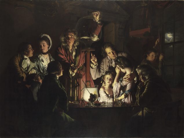 An indoor gathering in An Experiment on a Bird in the Air Pump shows a scientist operating a glass air pump containing a bird while adults and children react with curiosity and distress under dramatic, focused light.