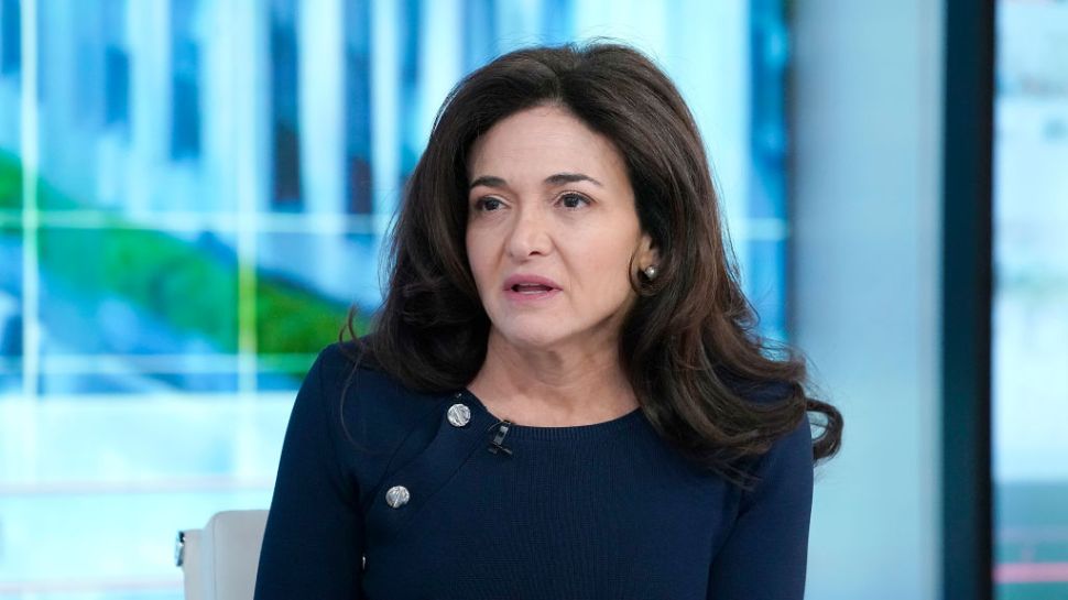 Sheryl Sandberg in a navy blue dress.