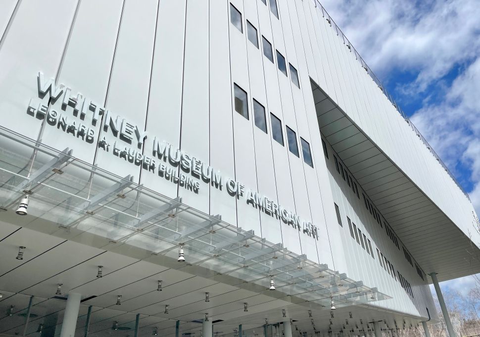 Exterior view of the Whitney Museum of American Art’s Leonard A. Lauder Building, showing its angled steel facade, glass canopy and upper-level cantilever against a partly cloudy sky.
