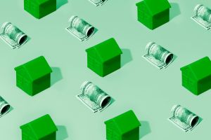 Repeating pattern of green houses and rolled hundred dollar bills