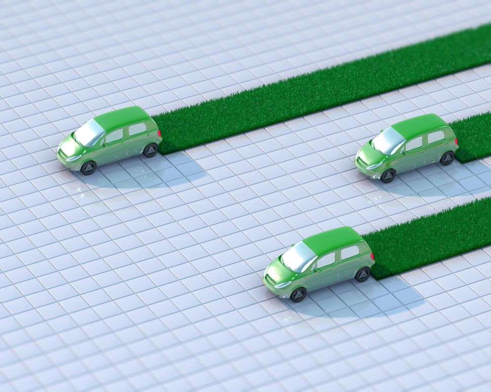 Rendering of electric vehicles driving on a tiles, each leaving behind a trail of grass