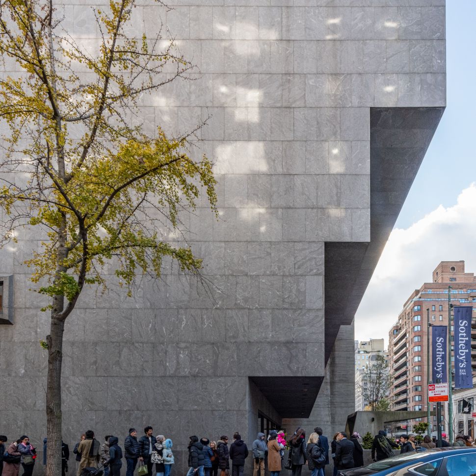 A long line of visitors stretches along the sidewalk outside the Breuer building’s stone façade as people wait to enter Sotheby’s new auction venue.